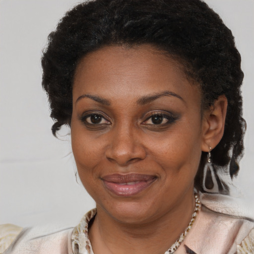 Joyful black adult female with short  brown hair and brown eyes