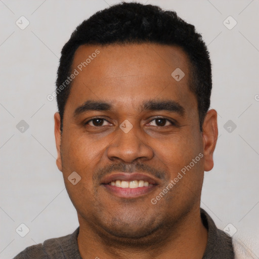 Joyful latino young-adult male with short  black hair and brown eyes