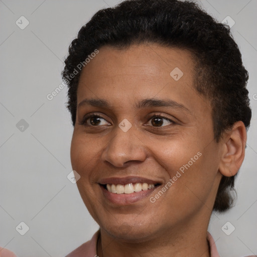 Joyful black young-adult female with short  brown hair and brown eyes