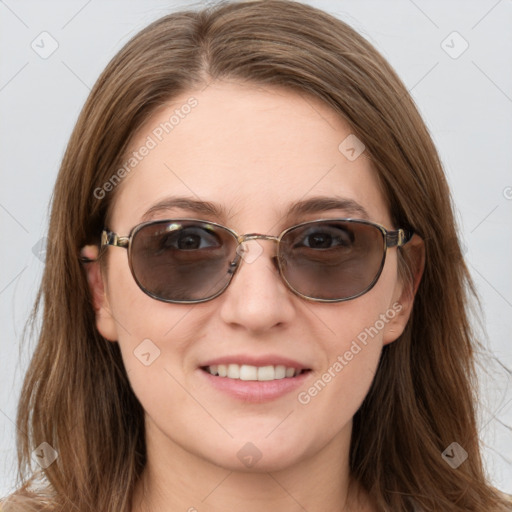 Joyful white young-adult female with long  brown hair and blue eyes