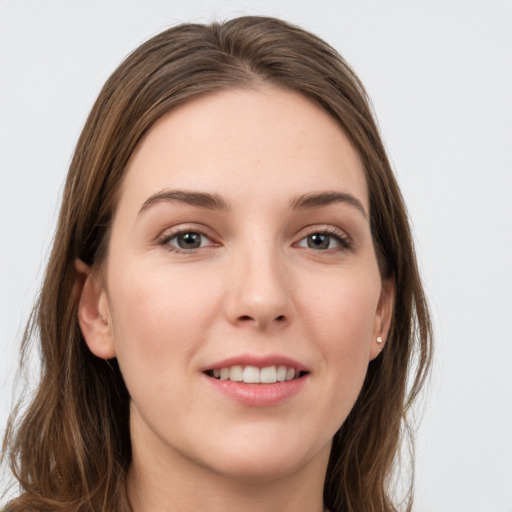 Joyful white young-adult female with long  brown hair and grey eyes