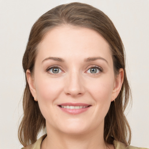 Joyful white young-adult female with medium  brown hair and blue eyes