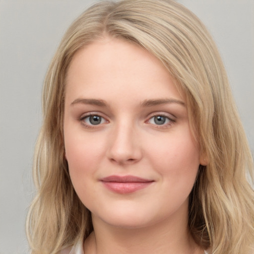 Joyful white young-adult female with long  brown hair and blue eyes