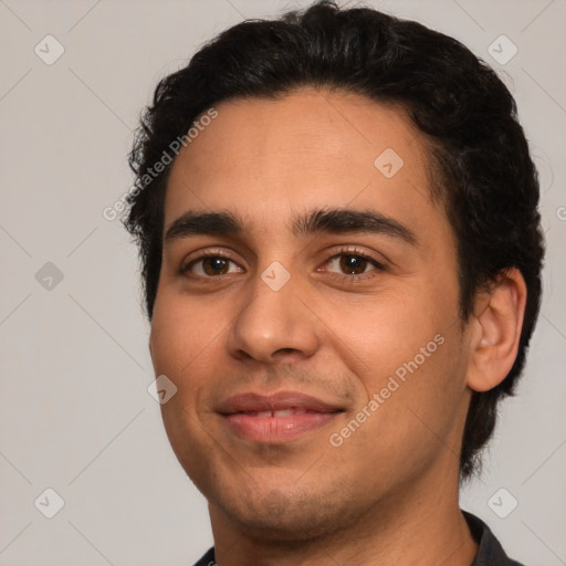 Joyful white young-adult male with short  black hair and brown eyes