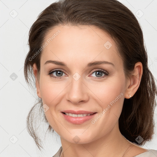 Joyful white young-adult female with medium  brown hair and grey eyes