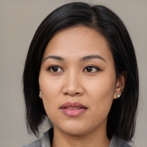 Joyful asian young-adult female with medium  black hair and brown eyes
