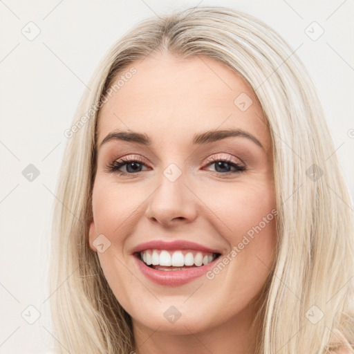 Joyful white young-adult female with long  brown hair and blue eyes