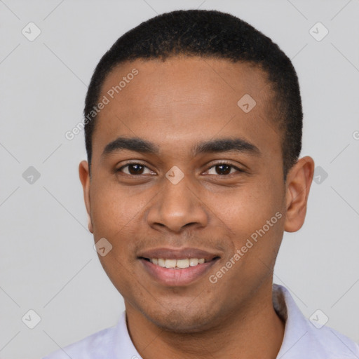 Joyful black young-adult male with short  black hair and brown eyes