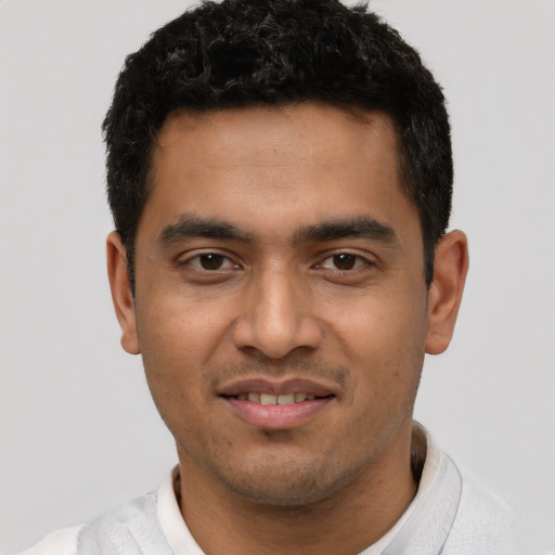 Joyful asian young-adult male with short  brown hair and brown eyes