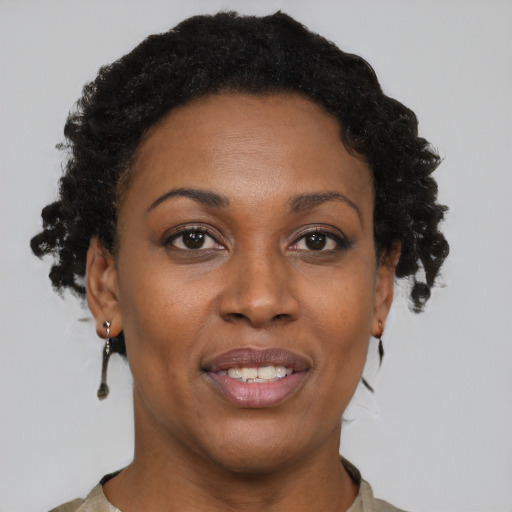 Joyful black adult female with short  brown hair and brown eyes