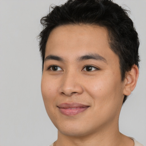 Joyful asian young-adult male with short  brown hair and brown eyes