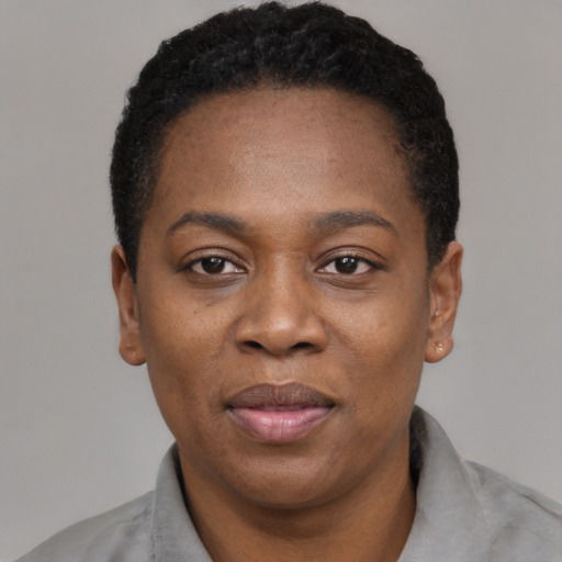 Joyful black adult female with short  black hair and brown eyes