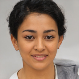 Joyful latino young-adult female with short  brown hair and brown eyes