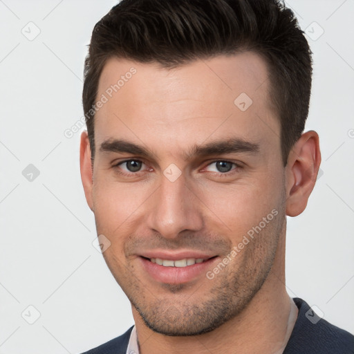 Joyful white young-adult male with short  brown hair and brown eyes