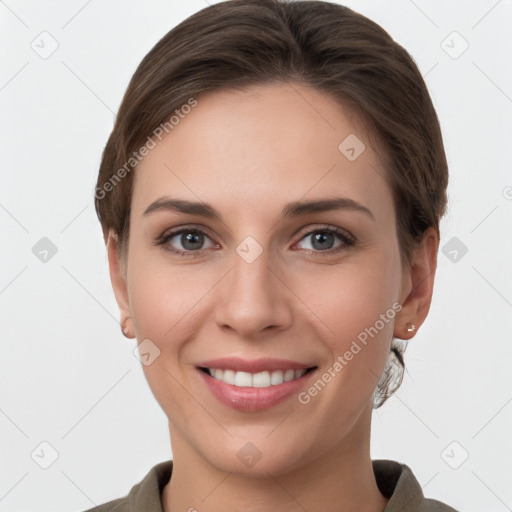 Joyful white young-adult female with short  brown hair and grey eyes