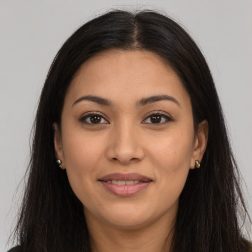 Joyful latino young-adult female with long  brown hair and brown eyes