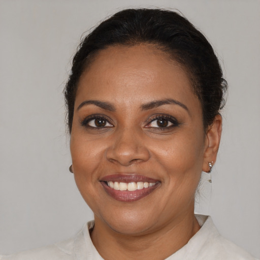 Joyful black young-adult female with short  brown hair and brown eyes
