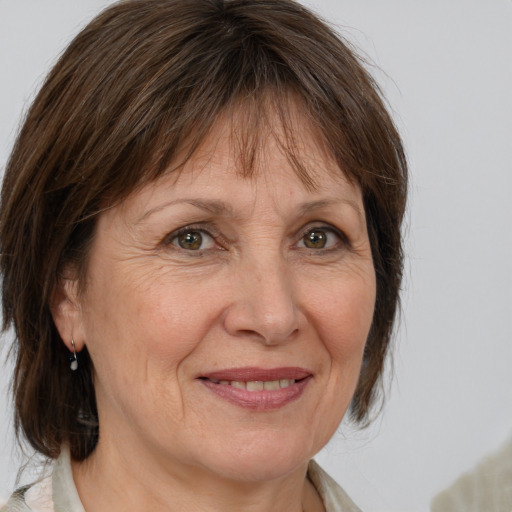 Joyful white adult female with medium  brown hair and grey eyes