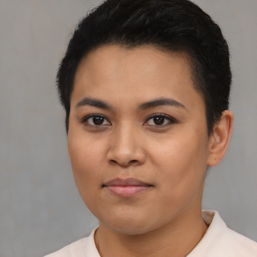 Joyful latino young-adult female with short  black hair and brown eyes