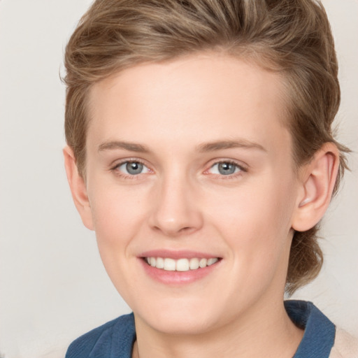 Joyful white young-adult female with medium  brown hair and blue eyes