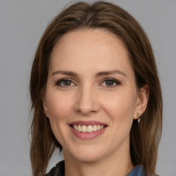 Joyful white adult female with medium  brown hair and grey eyes