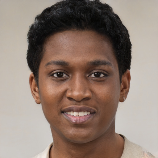 Joyful black young-adult female with short  black hair and brown eyes