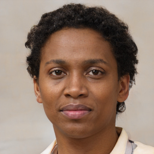 Joyful black adult female with short  brown hair and brown eyes