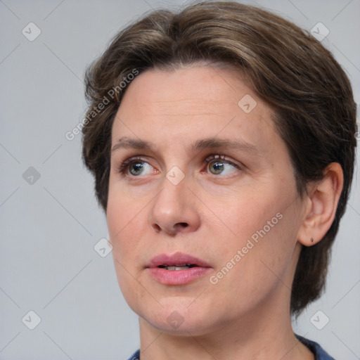 Joyful white adult female with medium  brown hair and grey eyes