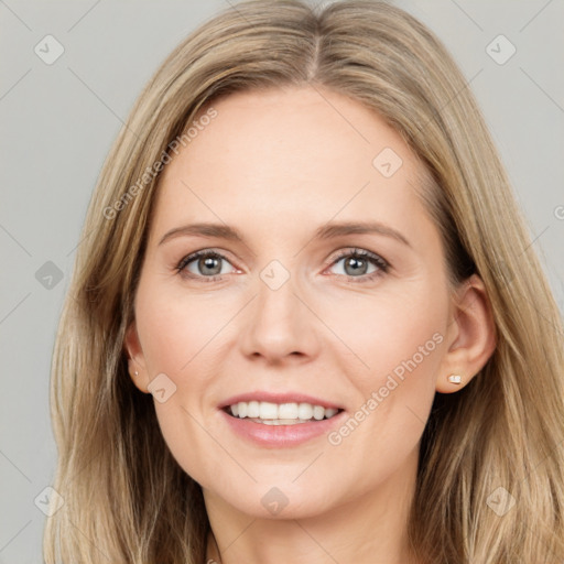 Joyful white young-adult female with long  brown hair and grey eyes