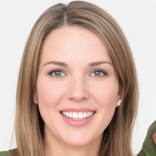 Joyful white young-adult female with long  brown hair and green eyes