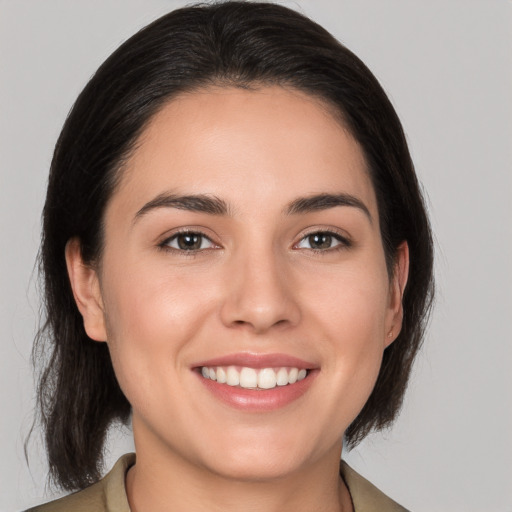 Joyful white young-adult female with medium  brown hair and brown eyes