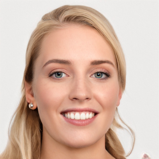 Joyful white young-adult female with long  brown hair and blue eyes