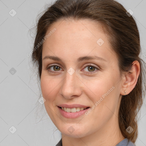 Joyful white young-adult female with long  brown hair and grey eyes