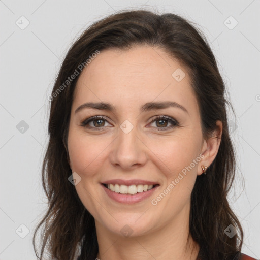 Joyful white adult female with long  brown hair and brown eyes