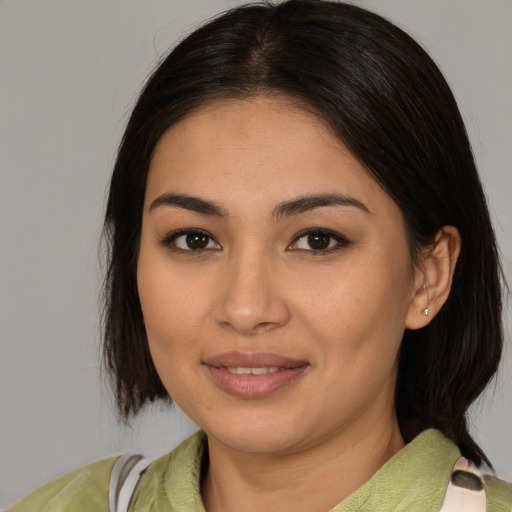 Joyful asian young-adult female with medium  brown hair and brown eyes