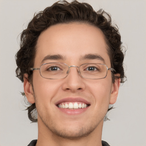 Joyful white young-adult male with short  brown hair and green eyes