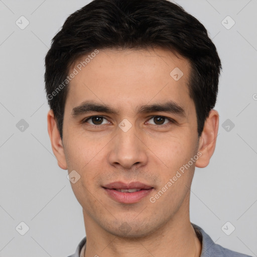 Joyful white young-adult male with short  black hair and brown eyes