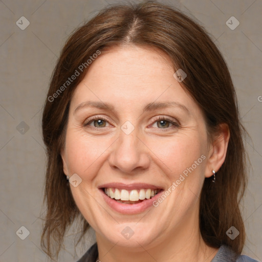 Joyful white adult female with medium  brown hair and grey eyes