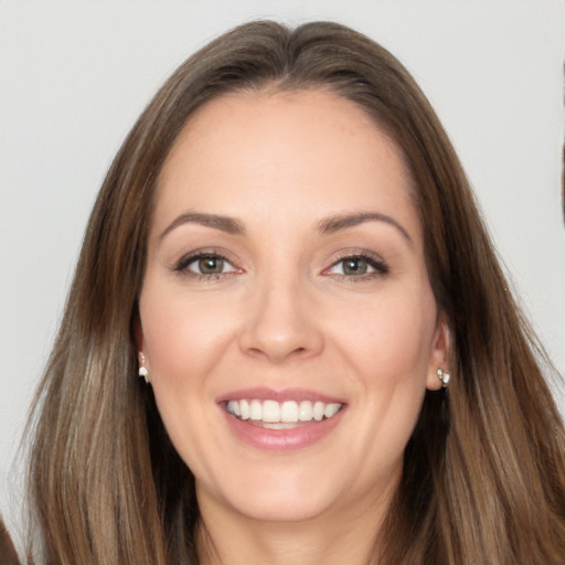 Joyful white young-adult female with long  brown hair and brown eyes