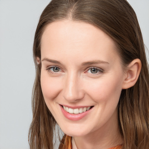 Joyful white young-adult female with long  brown hair and grey eyes