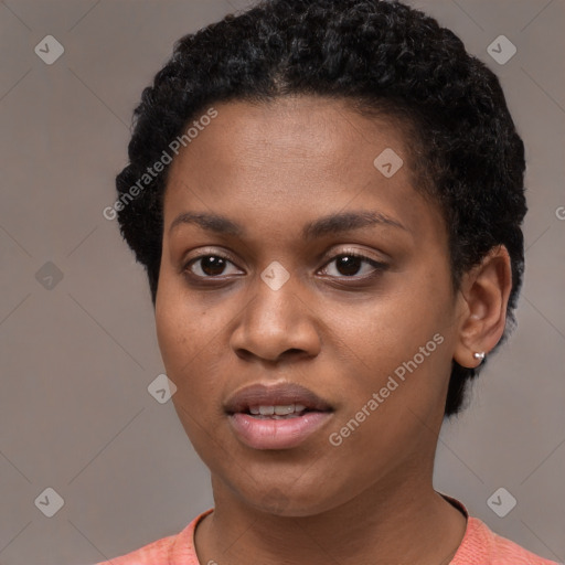 Joyful black young-adult female with short  black hair and brown eyes