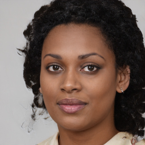 Joyful black young-adult female with medium  black hair and brown eyes