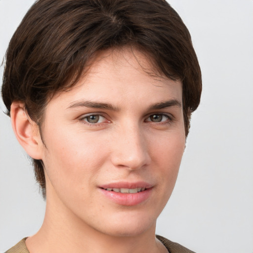 Joyful white young-adult female with short  brown hair and grey eyes