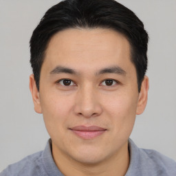 Joyful asian young-adult male with short  brown hair and brown eyes