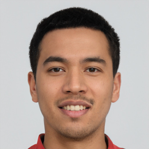 Joyful latino young-adult male with short  black hair and brown eyes