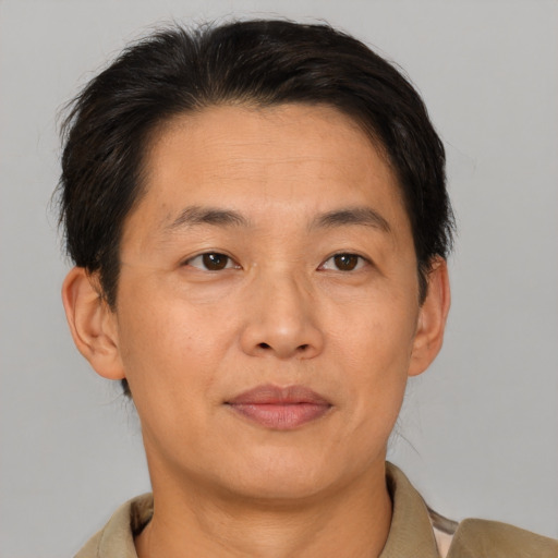 Joyful asian adult male with short  brown hair and brown eyes
