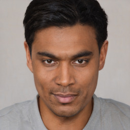 Joyful asian young-adult male with short  black hair and brown eyes