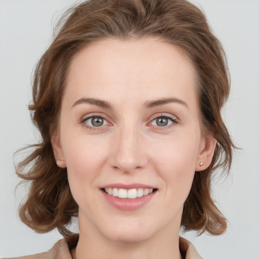 Joyful white young-adult female with medium  brown hair and blue eyes