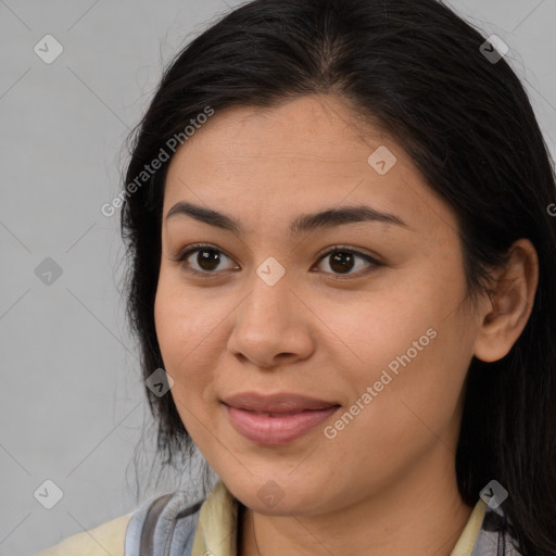 Joyful latino young-adult female with long  brown hair and brown eyes