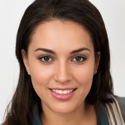 Joyful white young-adult female with long  brown hair and brown eyes